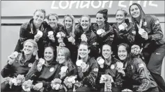  ??  ?? The U.S. team poses with their gold medals after their win over Spain in their Women's Gold Medal water polo match during the London 2012 Olympic Games August 9, 2012. REUTERS/Laszlo Balogh