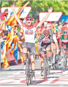  ?? — AFP photo ?? Lotto Soudal’s Belgian cyclist Jelle Wallays celebrates as he wins the 18th stage of the 73rd edition of “La Vuelta”Tour of Spain cycling race, a 186.1 km flat route from Egea de los Caballeros to Lleida, on September 13, 2018.