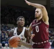  ?? JESSICA HILL - THE ASSOCIATED PRESS ?? UConn’s Kentan Facey, left, drives around Temple’s Obi Enechionyi­a, right, in the second half Wednesday night in Storrs.