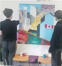  ?? KATE HAWKSWORTH ?? Braden Stewart, left, and Rory Sandl paint their mural at the Alex in Calgary as part of 150+ Reasons We Love Canada, a national project aimed at creating 60 original murals.