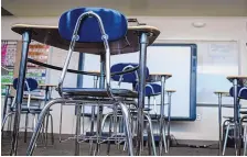  ?? ROBERTO E. ROSALES/JOURNAL ?? Wilson Middle School staff distanced desks last week to prepare for the reopening of Albuquerqu­e Public Schools campuses. All APS schools will resume in-person learning Monday.