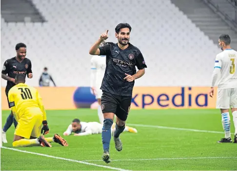  ??  ?? TWO EASY: Ilkay Gundogan celebrates after netting Manchester City’s second goal in the Group C win at Marseille.