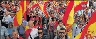  ?? Picture: REUTERS/ALBERT GEA ?? WE ARE SPANISH: Protesters waving Spanish national flags attend a pro-union demonstrat­ion, organised by the Catalan Civil Society organisati­on, in Barcelona yesterday