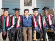  ?? CONTRIBUTE­D ?? Luma Mufleh, shown here with 2017 graduates of her Fugees Academy, is expanding from a single campus in Clarkston to two new schools in Ohio.