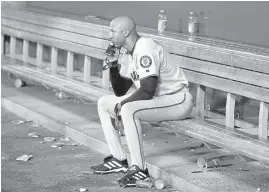  ?? MARK J. TERRILL/ASSOCIATED PRESS ?? The Giants’ Tom Goodwin is left alone to reflect after the Angels came roaring back to win the World Series in 2002. San Francisco was up 3-2 in the series before falling.