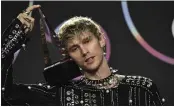  ?? JORDAN STRAUSS — INVISION ?? Machine Gun Kelly, winner of the award for favorite rock artist, poses in the press room at the American Music Awards on Sunday.