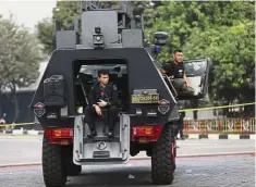  ??  ?? Breathing space: Police officers resting in an armoured vehicle parked outside the detention centre in Depok, West Java. — AP