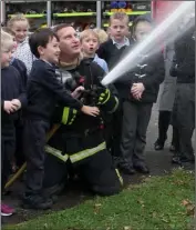  ??  ?? Fireman Davy Lynch helped by Robert Banville.