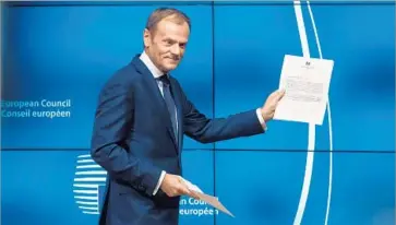  ?? Aurore Belot AFP/Getty Images ?? EUROPEAN COUNCIL President Donald Tusk shows the letter from Britain that starts the process for departing the EU. “There is no reason to pretend this is a happy day, neither in Brussels nor in London,” he said.