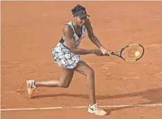  ?? SUSAN MULLANE, USA TODAY SPORTS ?? Venus Williams returns a shot during her 6- 4, 7- 6 ( 7- 3) victory Sunday against Qiang Wang in the French Open first round.