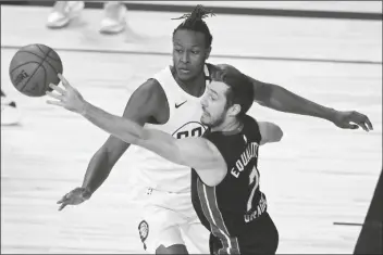  ?? ASSOCIATED PRESS ?? MIAMI HEAT’S GORAN DRAGIC (7) PASSES around Indiana Pacers’ Myles Turner (33) during the first half of a NBA first round playoff game on Monday in Lake Buena Vista, Fla.