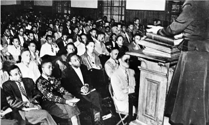  ?? Photograph: AP ?? Martin Luther King, third from left, listens to a speaker during an assembly at Morehouse College, in Atlanta in 1948. King subsequent­ly graduated from the college with a BA in sociology.