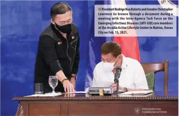  ??  ?? President Rodrigo Roa Duterte and Senator Christophe­r Lawrence Go browse through a document during a meeting with the Inter-Agency Task Force on the Emerging Infectious Diseases (IATF-EID) core members at the Arcadia Active Lifestyle Center in Matina, Davao City on Feb. 15, 2021.