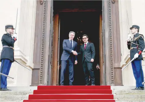  ?? — AFP ?? US Secretary of State Antony Blinken (L) shakes hands with French FM Stephane Sejourne (R) prior to their meeting at the Ministry of Foreign Affairs in Paris.