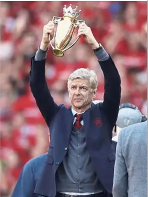  ?? — AP ?? Time to go: Arsenal’s French manager Arsene Wenger holding a trophy he was presented with after the match against Burnley at the Emirates on Sunday. The match is Wenger’s last home game in charge after announcing in April he will stand down as Arsenal...