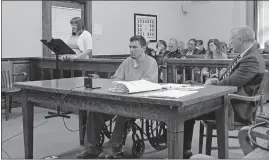  ?? [MARY BETH LANE/DISPATCH] ?? Defendant Joshua Conrad, seated in a wheelchair, listens as Stacey Stevens reads a statement at his sentencing in a Hocking County courtroom Tuesday about the impact of Conrad’s murder of her father, Gary, in 2016. With Conrad is his attorney, Michael...