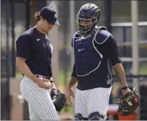  ?? FRANK FRANKLIN II - THE ASSOCIATED PRESS ?? New York Yankees’ Gerrit Cole, left, talks to catcher Gary Sanchez after a spring training baseball workout Monday, Feb. 22, 2021, in Tampa, Fla.