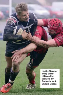  ??  ?? Held: Chinnor wing Luke Hibberd is tackled by Redruth lock Shaun Buzza