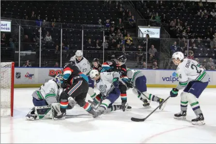  ?? PAIGE BEDNORZ/Special to ONG ?? Kelowna Rockets Pavel Novak (from left), Andrew Cristall and Adam Kydd crash the Seattle Thunderbir­ds net on Saturday night in Kent, Wash., during their WHL playoff series.