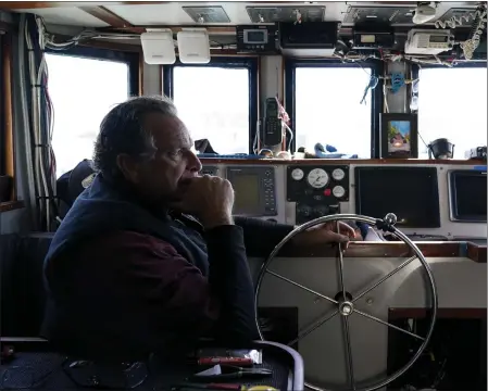  ?? PHOTOS BY GODOFREDO A. VÁSQUEZ — THE ASSOCIATED PRESS ?? Bob Maharry sits inside his fishing boat docked at Pier 45in San Francisco, Monday. This would usually be a busy time of year for Maharry and his crew as salmon fishing season approaches. On April 7, the Pacific Fishery Management Council, the regulatory group that advises federal officials, will take action on what to do about the 2023 season for both commercial and recreation­al salmon fishing.