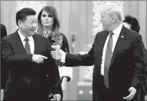  ?? The Associated Press ?? DIPLOMATIC DINNER: U.S. President Donald Trump and China’s President Xi Jinping arrive for the state dinner with the first ladies at the Great Hall of the People in Beijing, China, Nov. 9, 2017. Trump is closing in on a decision to impose punishing...