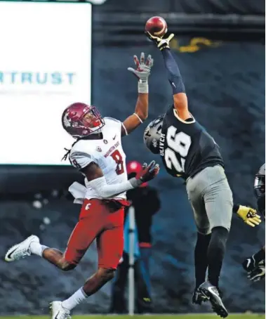  ??  ?? Colorado cornerback Isaiah Oliver knocks the ball away from Washington State’s Tavares Martin this season. The sophomore Oliver’s athletic play has become more prominent late in the season. Cliff Grassmick, Daily Camera