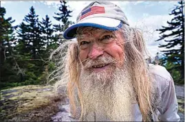  ?? ROBERT F. BUKATY / AP ?? M.J. Eberhart, 83, arrives on the summit of Mount Hayes on the Appalachia­n Trail on Sunday in Gorham, New Hampshire. Eberhart, who goes by the trail name of Nimblewill Nomad, is the oldest person to hike the entire 2,193-mile Appalachia­n Trail.