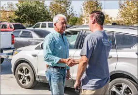  ?? Cory Rubin/The Signal ?? California gubernator­ial candidate John Cox, left, shakes hands with Santa Clarita resident Joseph LaRocca at the gas station of the Costco in Canyon Country on Wednesday.