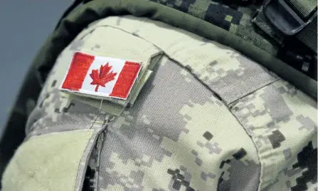  ?? THE CANADIAN PRESS FILES ?? A Canadian flag patch is shown on a soldier’s shoulder in Trenton, Ont., on Oct. 16, 2014. A landmark new study from Veterans Affairs Canada appears to confirm what many have long feared: Canadians who have served in uniform are at greater risk of...