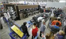  ?? CHARLIE RIEDEL — THE ASSOCIATED PRESS FILE ?? People line up to pay for their purchases as they shop during an early Black Friday sale at a Best Buy store on Thanksgivi­ng Day in Overland Park, Kan. Consumer spending rose a sharp 0.6 percent last month, the Commerce Department reported Thursday.