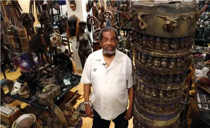  ?? Pictures: AFP ?? PASSIONATE. Collector of African art Eric Edwards stands among some of the pieces in his collection.