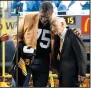  ?? AP PHOTO/GENE J. PUSKAR/FILE ?? Pittsburgh Steelers Pro Football Hall of Famer Joe Greene, left, hugs Steelers chairman Dan Rooney following a ceremony to retire Greene's jersey Nov. 2, 2014.