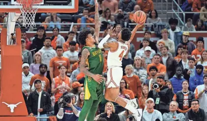  ?? SCOTT WACHTER/USA TODAY SPORTS ?? Texas guard Tyrese Hunter, right, shoots over Baylor forward Jalen Bridges in the second half on Jan. 30 at Moody Center in Austin, Texas.