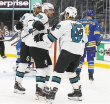  ?? Scott Kane / Associated Press ?? The Sharks’ Logan Couture (39) is congratula­ted by teammates Evander Kane (left) and Kevin Labanc after a firstperio­d goal.