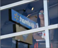  ?? THE ASSOCIATED PRESS ?? A restaurant employee looks at the scene of a mass shooting at a shopping complex Sunday in El Paso, Texas.