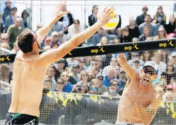  ?? Luis Sinco Los Angeles Times ?? NICK LUCENA tries to fire a shot past the outstretch­ed arms of 7-footer Ryan Doherty during the AVP Huntington Beach Open finals. Lucena and partner Phil Dalhausser won 21-16, 21-17.