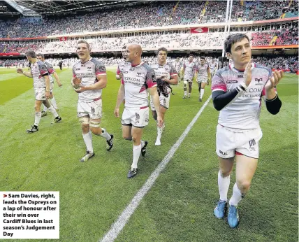  ??  ?? > Sam Davies, right, leads the Ospreys on a lap of honour after their win over Cardiff Blues in last season’s Judgement Day