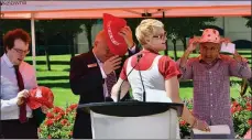  ?? To the Courier ?? JOHN McDONALD/Special
Renata Mills, front, asks media conference participan­ts – including Mayor Colin Basran, right – to wear some Canada Day regalia.