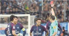  ?? — AFP ?? French referee Ruddy Buquet (right) shows a red card to PSG’s Neymar (centre) during the French L1 match.