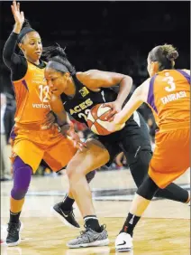  ?? Richard Brian ?? Las Vegas Review-journal @vegasphoto­graph Aces rookie forward A’ja Wilson, center, finds an opening between Mercury guards Briann January, left, and Diana Taurasi during Phoenix’s 92-80 victory Sunday at Mandalay Bay Events Center. Wilson had a...