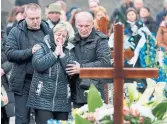  ?? JOE RAEDLE GETTY IMAGES ?? Relatives of a Ukrainian soldier mourn him during a burial ceremony Thursday in Lviv, Ukraine.