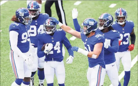  ?? Mike Stobe / Getty Images ?? James Bradberry (24) of the Giants celebrates after intercepti­ng a pass from Washington’s Kyle Allen at MetLife Stadium on Sunday.