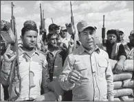  ?? AP/KHALID MOHAMMED ?? Hakim al-Zamili, (right) an Iraq parliament member and head of Security and Defense Committee, visits the front line during a battle against Islamic State militants in Tikrit, Iraq, on Monday.