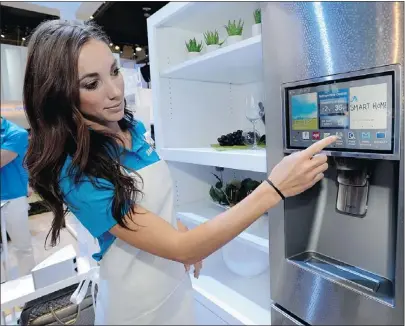  ?? — GETTY FILES ?? Smart fridges, such as this one displayed by Kai Madden, take connectivi­ty to new levels. But experts warn that hackers will look to exploit these types of web-enabled devices.