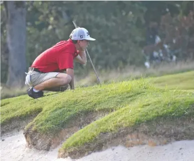  ?? STAFF PHOTO BY PATRICK MACCOON ?? Signal Mountain junior Peyton Ogle reads the green before a putt during Tuesday’s home match against Chattanoog­a Christian. Ogle shot 1-under-par 71 as the match’s medalist.