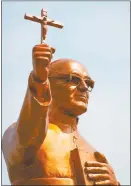  ?? KeN hawKiNS / Zuma PreSS / TNS ?? A golden statue of martyred Archbishop Oscar Romero stands across from the Plaza El Salvador Del Mundo (Savior of the World) in San Salvador, El Salvador.