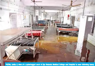  ??  ?? PATNA, India: A view of a waterlogge­d ward of the Nalanda Medical College and Hospital is seen following heavy rains in the Indian state of Bihar on Monday. — AFP