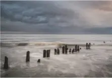  ??  ?? Groynes at Sandsend in North Yorkshire. When experienci­ng grey skies, look for a subject that chimes with the mood