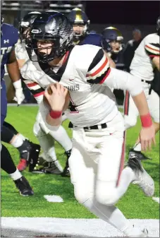  ?? TIMES photograph by Annette Beard ?? Falling short on a third-down play, Tate Busey went back to punt but when he saw a hole develop on the left side, the fleet field general dashed 17 yards down field to move the chains.