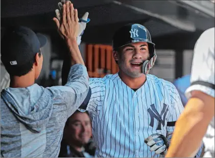  ?? FRANK FRANKLIN II/AP PHOTO ?? Gleyber Torres of the New York Yankees celebrates with teammates after hitting a home run during the first inning of the first game of Monday’s doublehead­er against the Baltimore Orioles at New York.